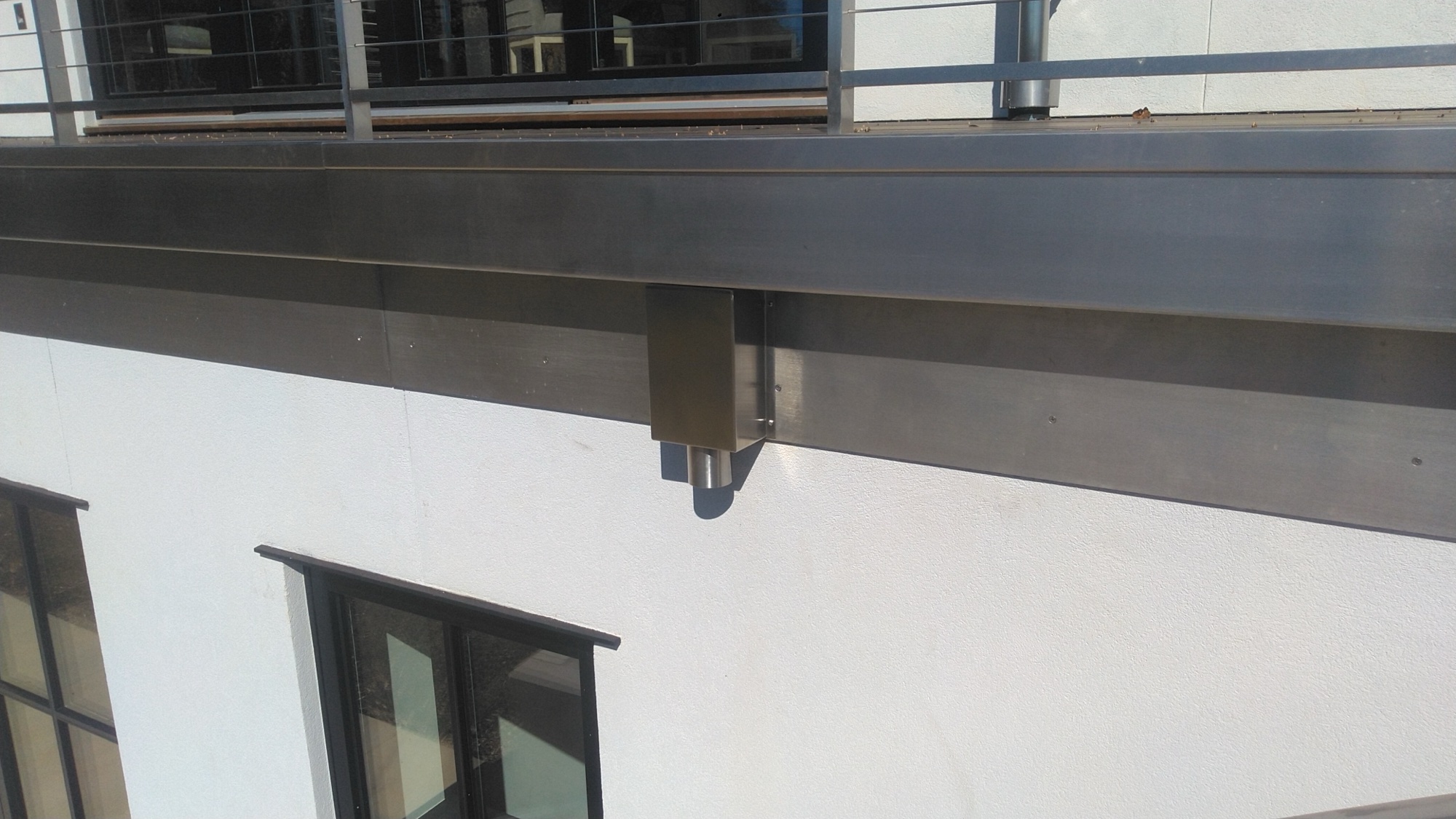 Custom stainless steel scupper leader box on the farmhouse eave