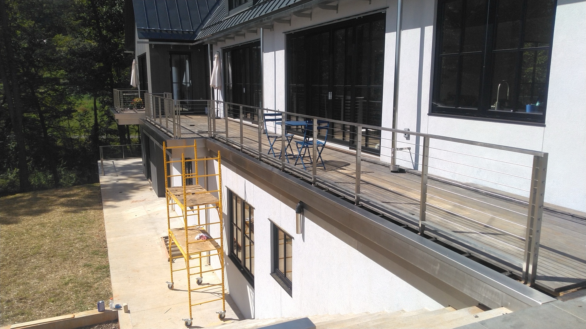 Second-story balcony with brushed stainless cable railings