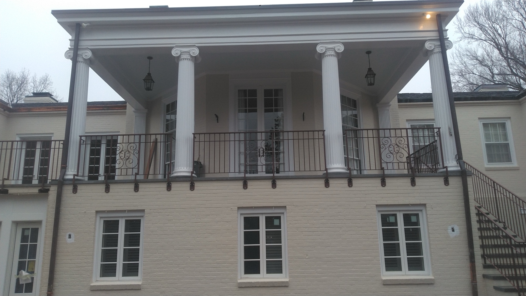 Rear of the mansion with Ionic columns and S-scroll monogram balcony railing