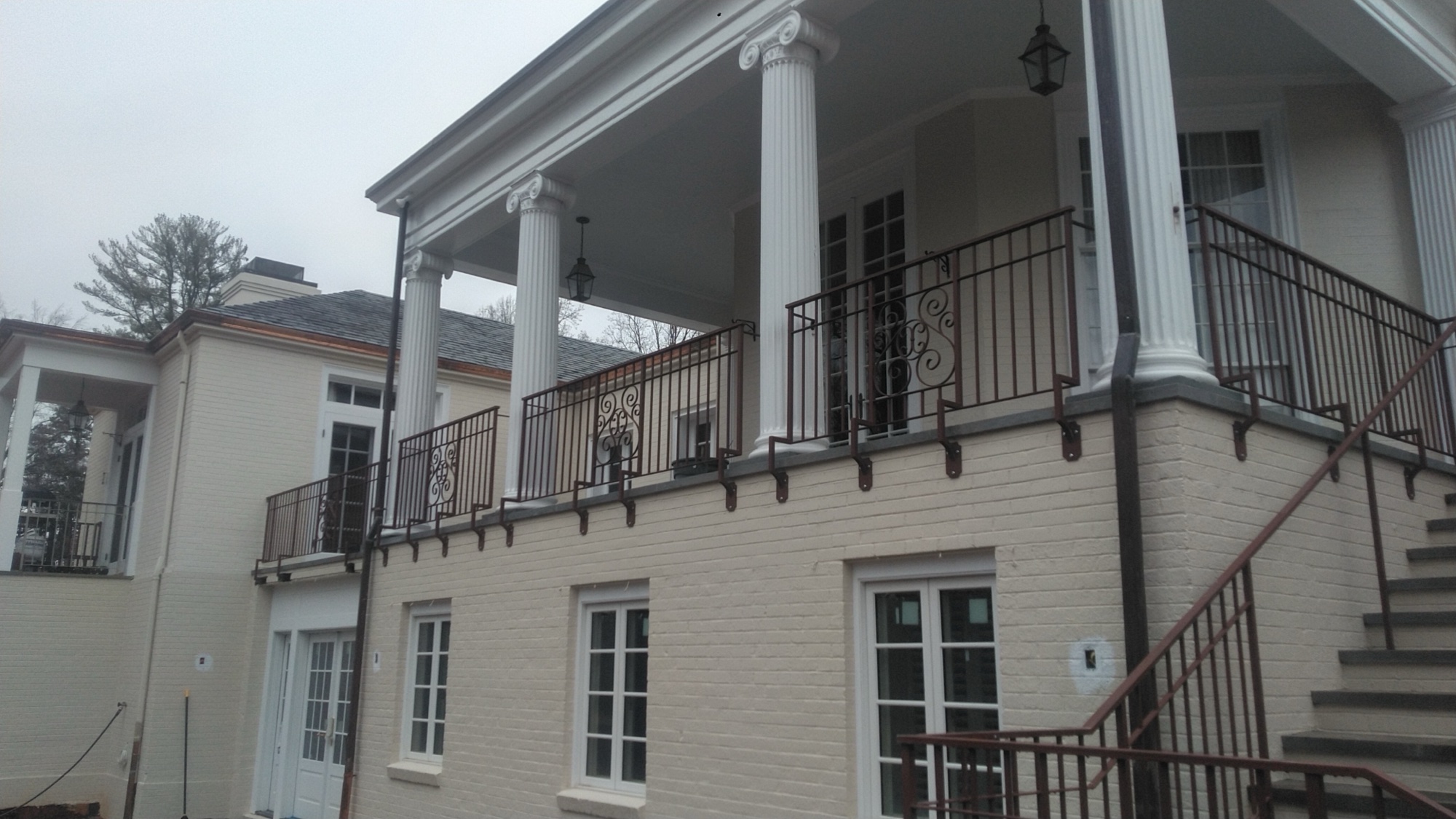 Wrought iron balcony with S-scroll monogram
